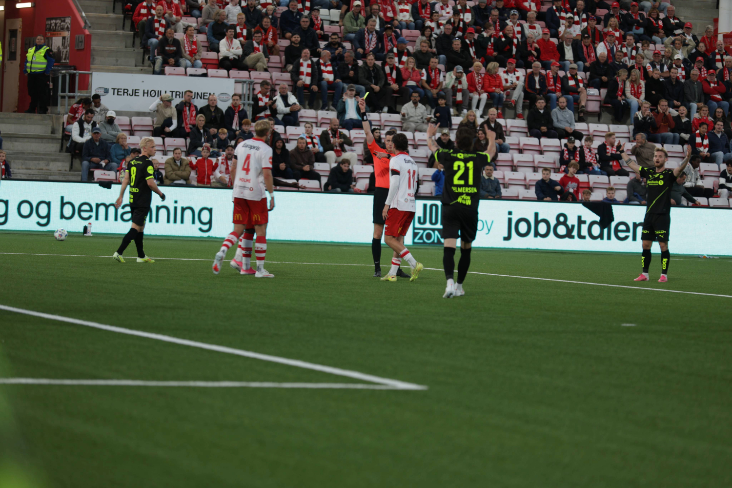 Sletner gir et gult kort til en Fredrikstad-spiller.