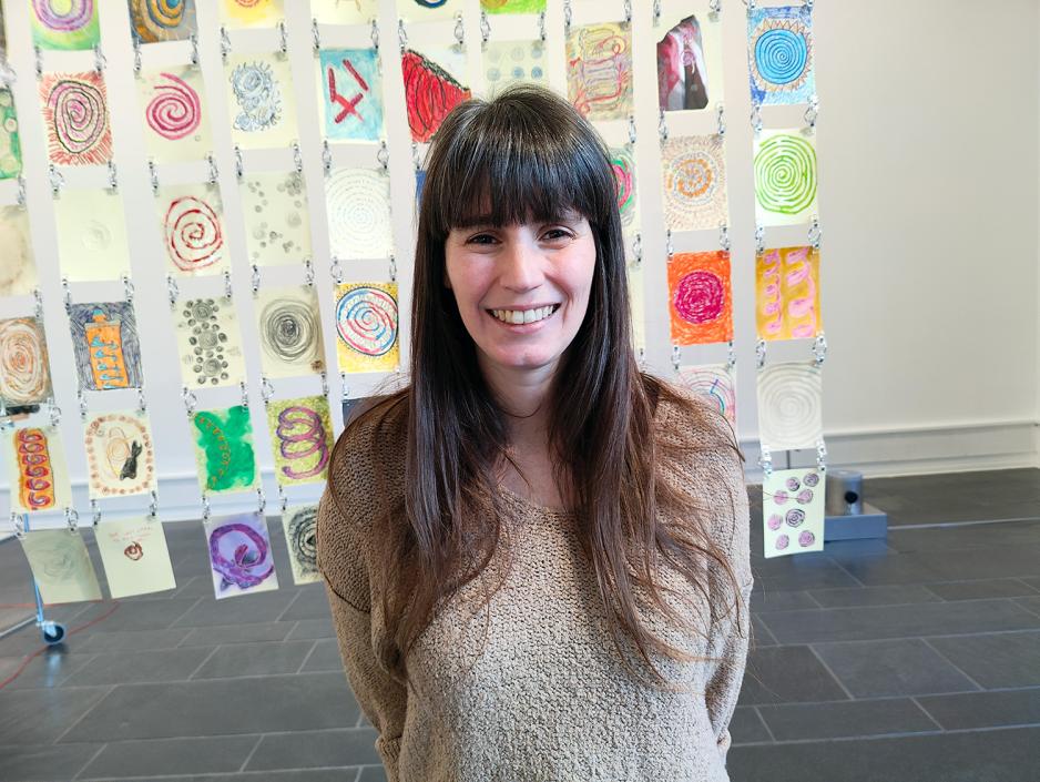 Dame som smiler. Langt brunt hår. Bakgrunn med hjemmelagde kort.