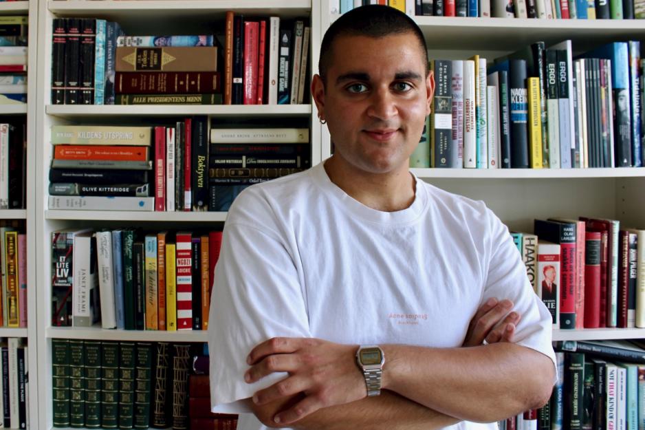 Rauand Ismail er fotografert foran en bokhylle.