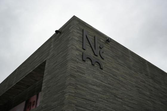 Foto av utsiden av Nasjonalmuseet foran en gr&aring; himmel