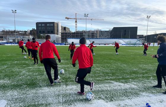 Fotballspillere som løper på banen 