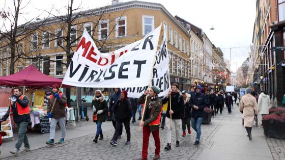 Vaksinemotstanderne fra gruppen, Røde luer, marsjerer gjennom Oslo med stort banner hvor det står: "media er viruset".