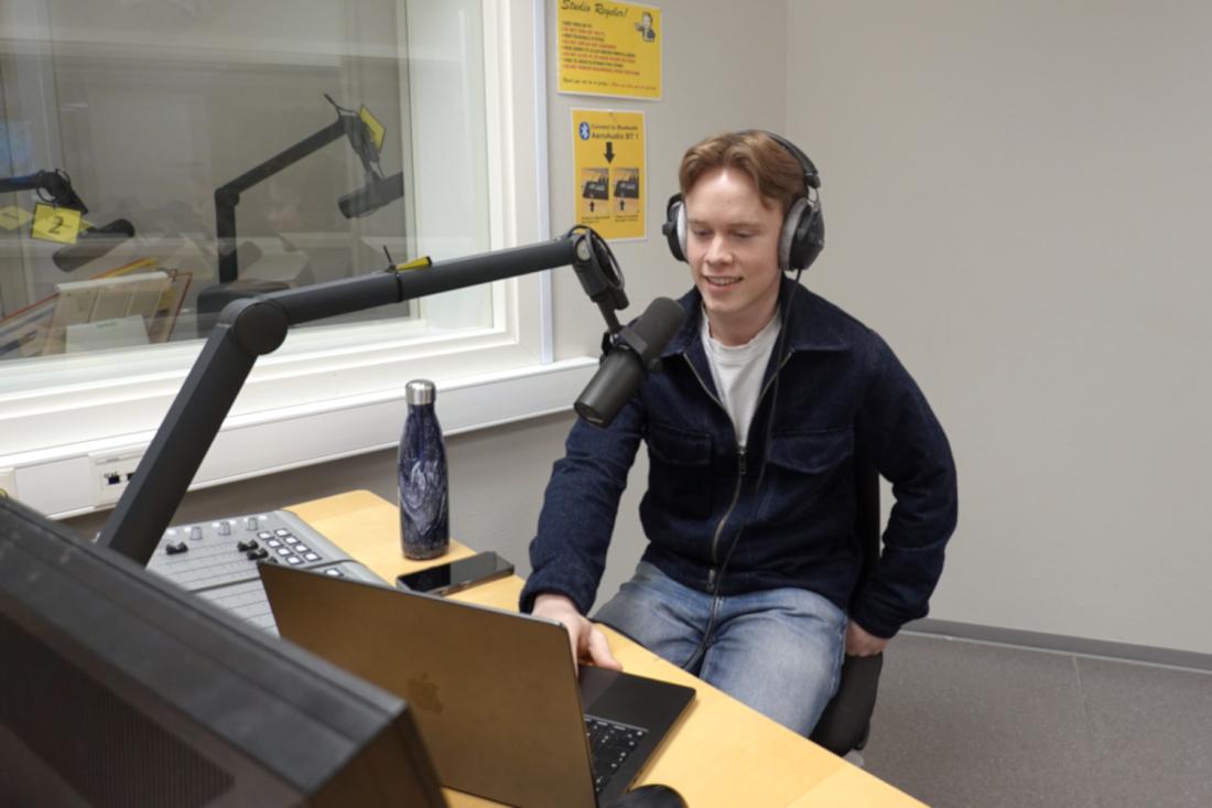 Gutt foran mikrofon i lydstudio